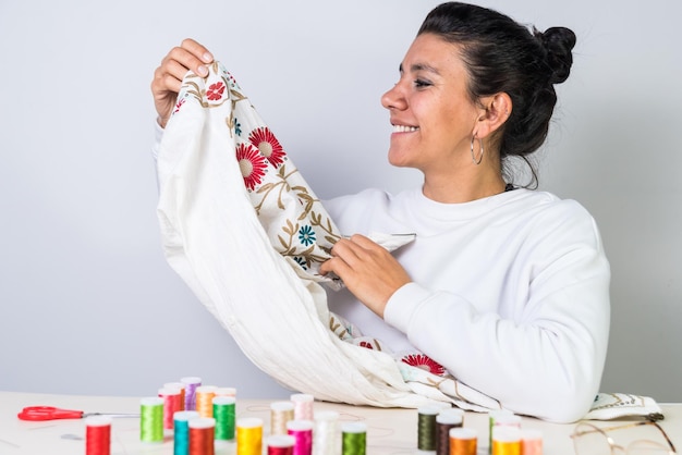 Smiling person holding embroidered cloth